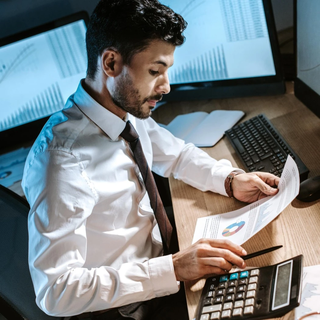 Payroll compliance expert reviewing salary reports and financial data