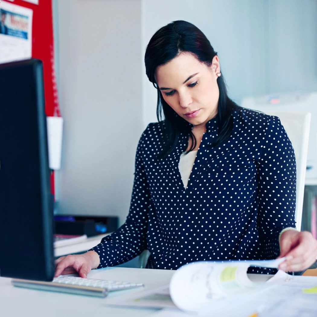 HR professional reviewing payroll documents and salary reports